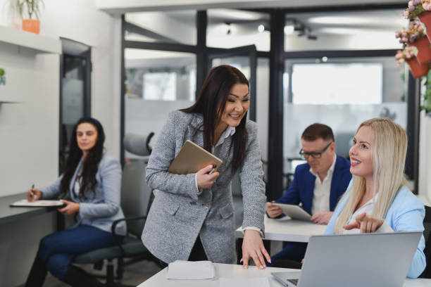 istock Female Supervisor Smiling While Giving Support on Task Sharing Positive Reactions to the Work 2195270909