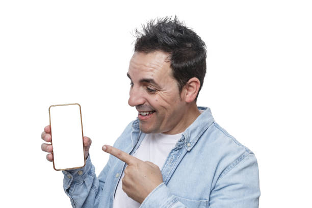 A man is smiling and pointing at a blank smartphone screen, appearing enthusiastic and engaged. The bright background emphasizes his joyful expression and the smartphone's prominence.