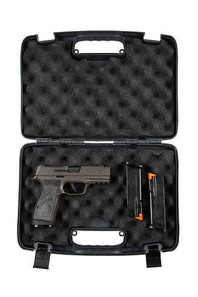 istock A black plastic case with foam padding contains a handgun and two magazines, showcasing a secure storage solution for firearms, isolated on a white background. 2195273788