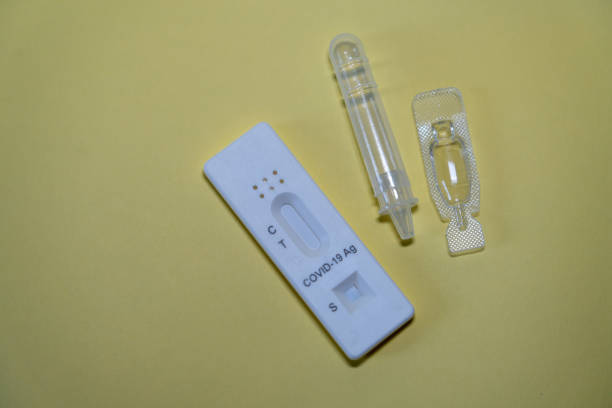 istock Covid-19 test kit on yellow background 2195275558