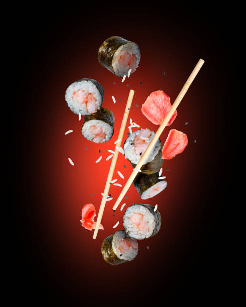 istock Levitating sushi rolls with marinated ginger and sesame isolated on a white background 2195280999
