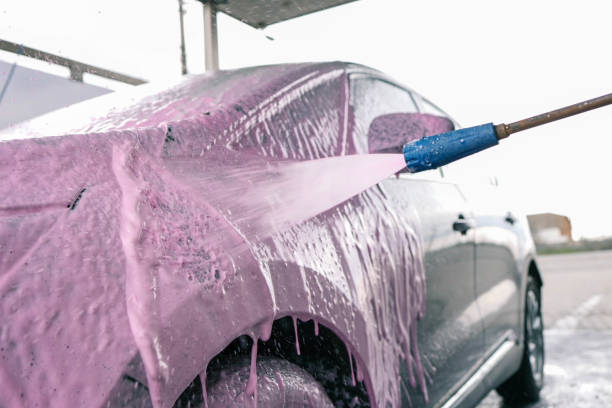 istock Hand washing car with pink foam, advertising 2195281247