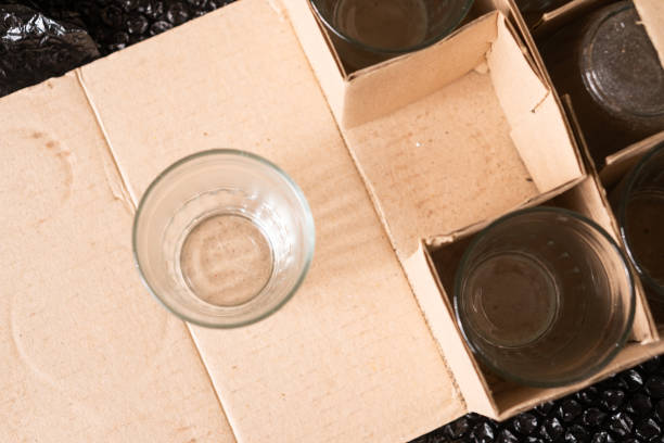 istock Overhead View of an Empty Glass on Cardboard Packaging 2195282320