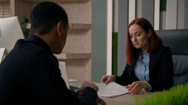 istock Two multiracial businesswoman and businessman work with computer business online project Caucasian woman consult African American man client customer service at office help with offer bank insurance 2195282806