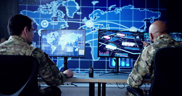 istock Cyber Technology Expert Monitors Security Cameras In Government Control Center 2195283710