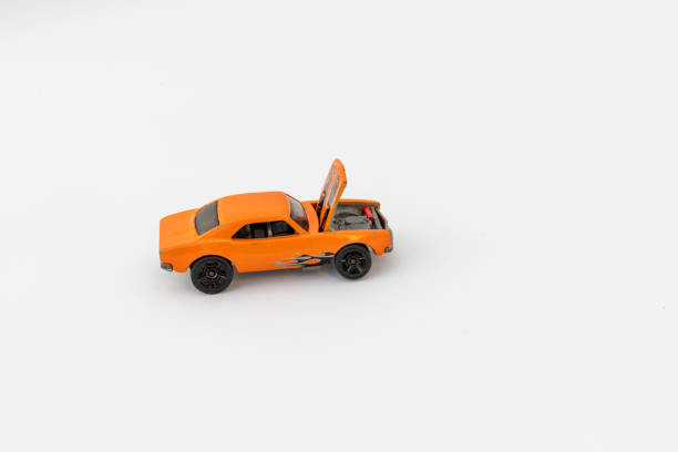Orange Toy Racing Car with Open Hood on White Background with Copy Space