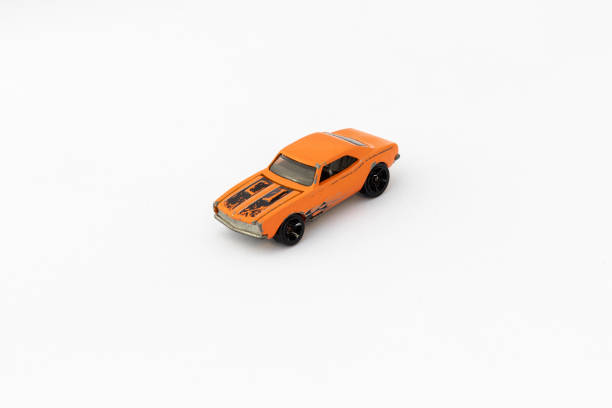 istock Miniature Orange Toy Car on White isolated Background 2195284107