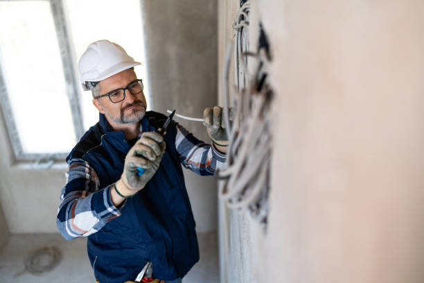 Electrician Working on Wiring With Pliers in a Residential Construction Site with Tools