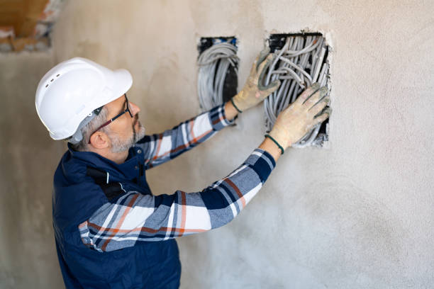 istock Electrician Installing Cables in Wall during Construction Wearing Protective Equipment 2195285244