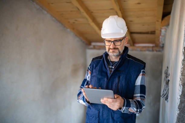 istock Construction Manager Reviewing Plans on Digital Tablet at Worksite 2195285409