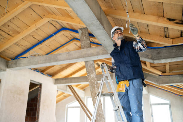 istock Electrician Inspecting Wiring in a Wooden and Concrete Rooftop Interior 2195286084