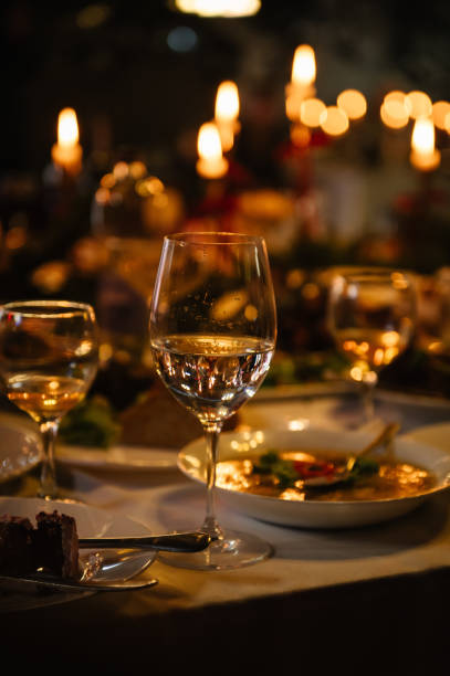 istock Romantic dinner setup at night. Wine glasses and candle lights. Table setting for a couple, Valentine's Day evening, burning candles for a surprise marriage proposal. Candlelight date in a restaurant. 2195286227