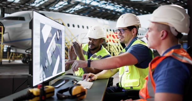 istock Diverse group of technicians repair air engines at hangar. Developing aircraft 2195287031