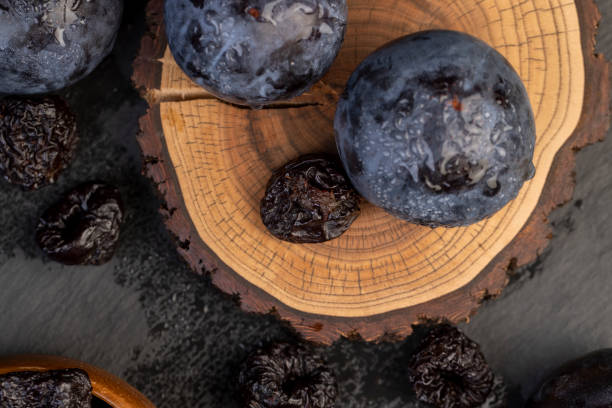 istock ripe purple plums and dried plums 2195287598