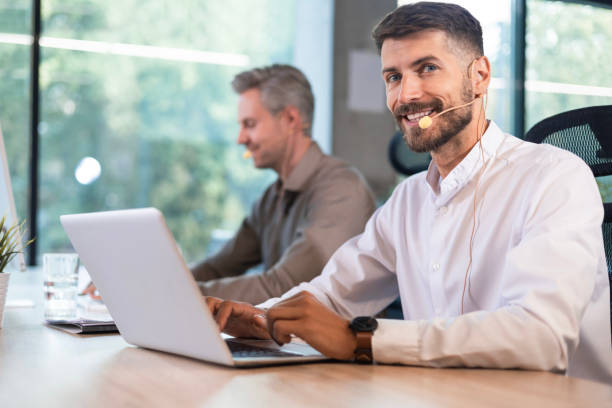 istock Young handsome male customer support phone operator with headset working in call center. 2195290820