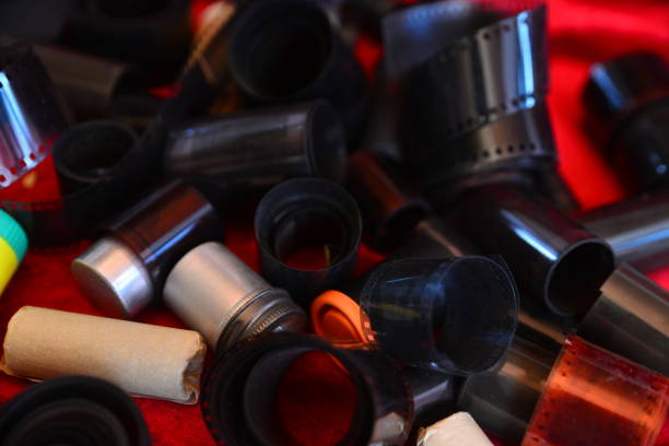 istock Negative 35mm film rolls and cassettes isolated on red 2195291178