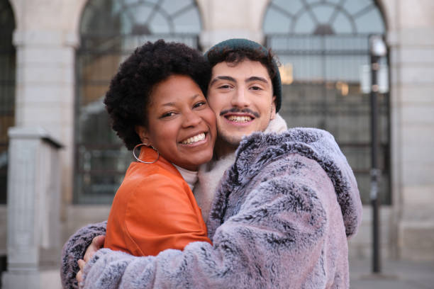 istock Happy multi-ethnic couple hugging in the city 2195291179