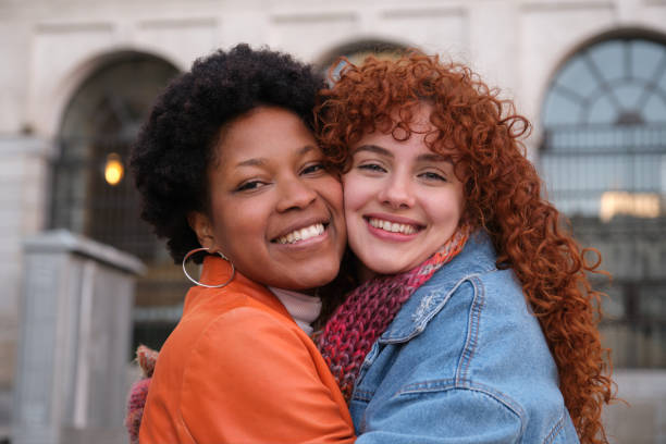 istock Two young women hugging and smiling at camera 2195291632