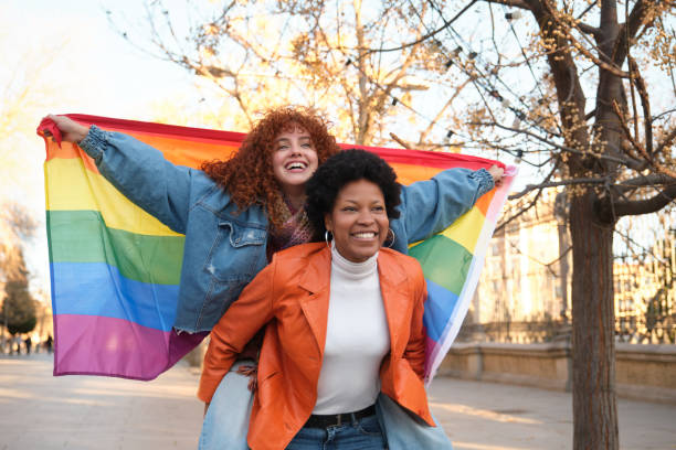 istock Two women holding rainbow flag and having fun together 2195292778