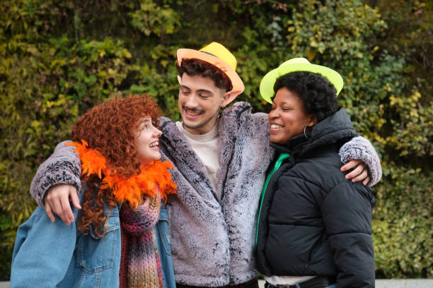 istock Three young friends hugging and smiling at carnival party 2195293100