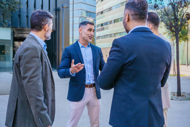 istock Businessmen Having a Discussion Outdoors in a Modern City 2195294124