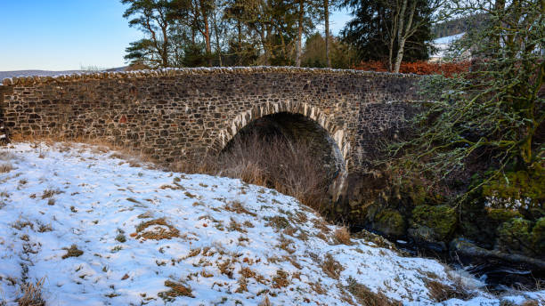 istock River Tweed flows under road bridge at Tweedsmuir. 2195296675