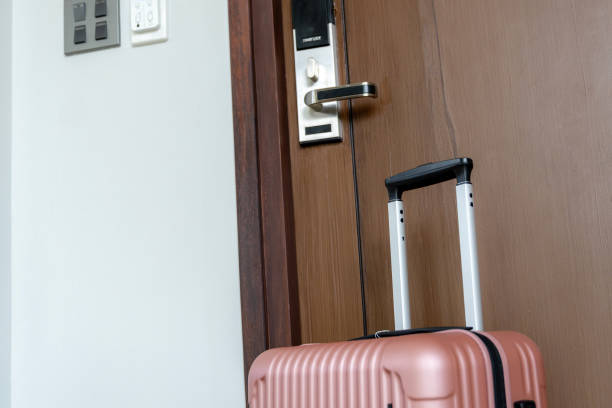 istock A suitcase placed in front of a hotel room door 2195300006