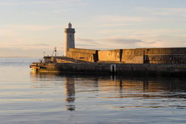 21 January 2025. Buckie Habour,Moray,Scotland. This is the last of the days winter sun catching the North Pier Lighthouse at Buckie Habour.