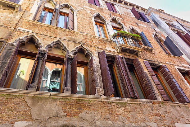 italian window on the building with an stone wall