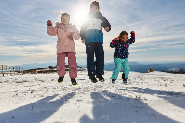 istock Happy kids enjoying winter snow 2195310823