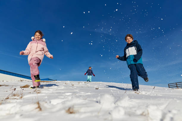 istock Happy kids enjoying winter snow 2195310957