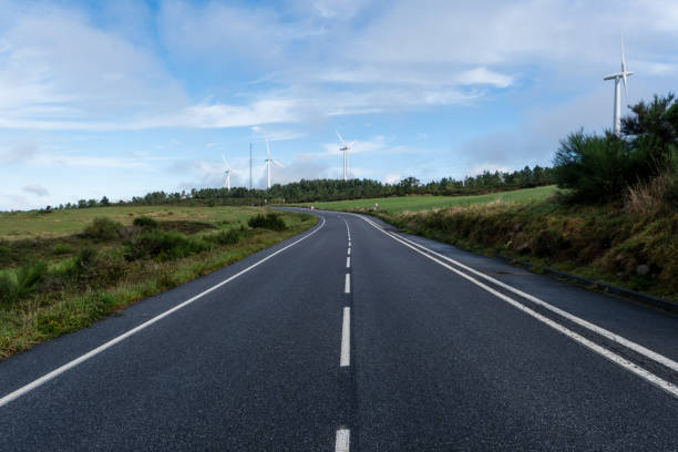 Empty road in the countryside with wind turbines