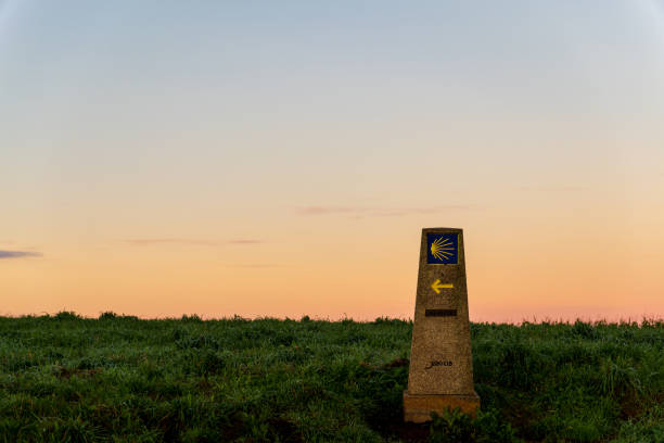 Sunrise on a Camino compostelle stone with distance, Spain