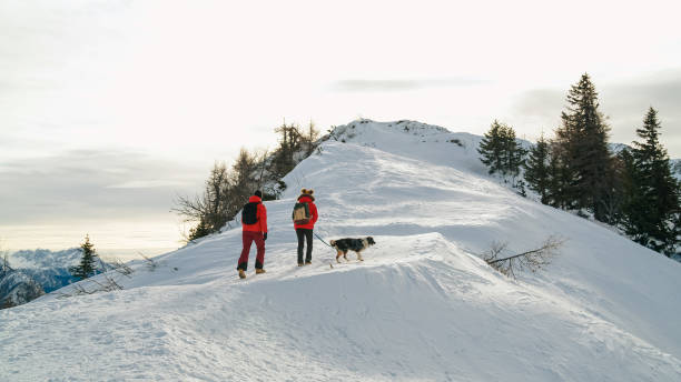istock Couple enjoys a day outdoors on a snowy mountain 2195311861