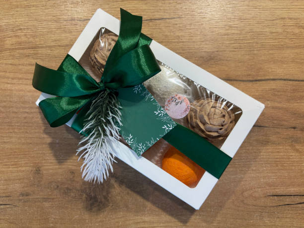 istock Marshmallows in gift box. Homemade marshmallows shaped like cones and tangerines. Box with labels for the brand. 2195312069