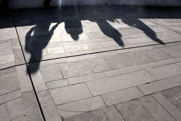 istock Shadows of sitting four people appear 2195312098