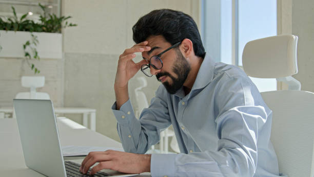 istock Arabian Indian man tired exhausted worker manager working laptop computer sick businessman rubbing dry itchy eyes male business employer overwork in office take off glasses feel headache bad vision 2195313736