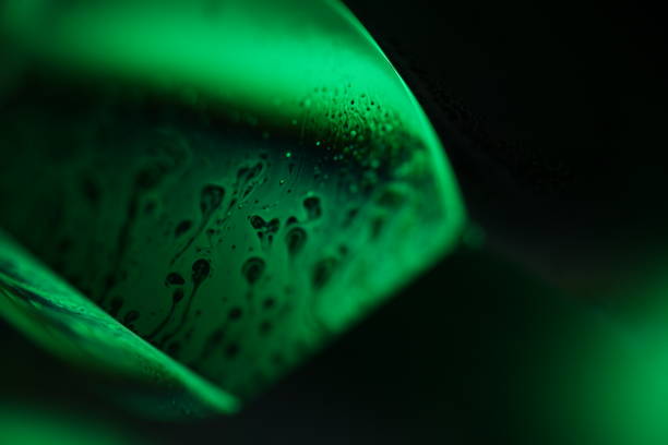 Bright water surface reflection, green on black, natural phenomena