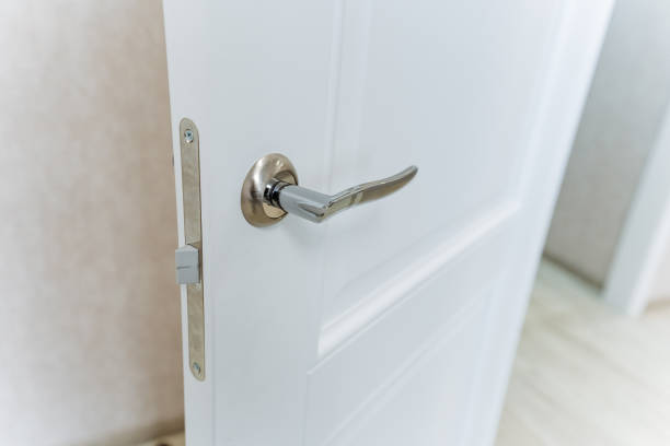 istock The image captures a closeup view of a pristine white door that features an elegantly designed silver handle, which adds a stylish touch to the overall appearance of the door 2195328465
