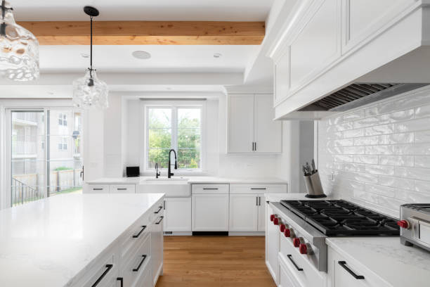 istock A white kitchen detail with a white subway tile backsplash and wood beam ceiling. 2195332690