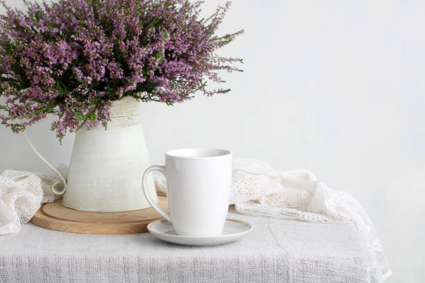 istock White mug and heather flowers creating cozy home atmosphere 2195333981