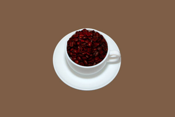Cup and saucer with coffee beans close-up view concept background