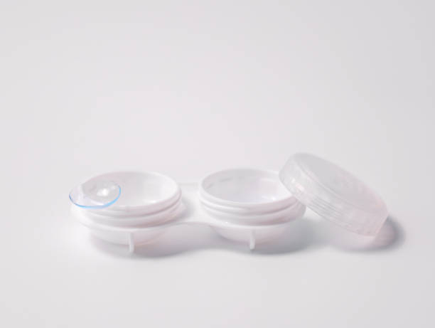 istock White contact lens case with a transparent lens on one side, placed on a clean white background. Minimalist design representing vision correction, hygiene, and eye care essentials 2195334232