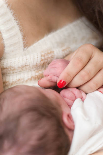 istock Young mother breastfeeding newborn baby 2195334396