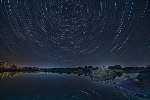istock Star Trails Reflected in a Still Lake at Los Barruecos, Caceres 2195335097