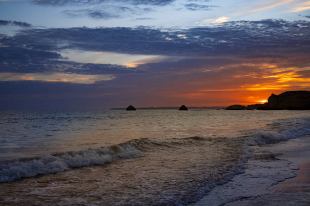Golden Sunset Over the Waves at Praia da Rocha