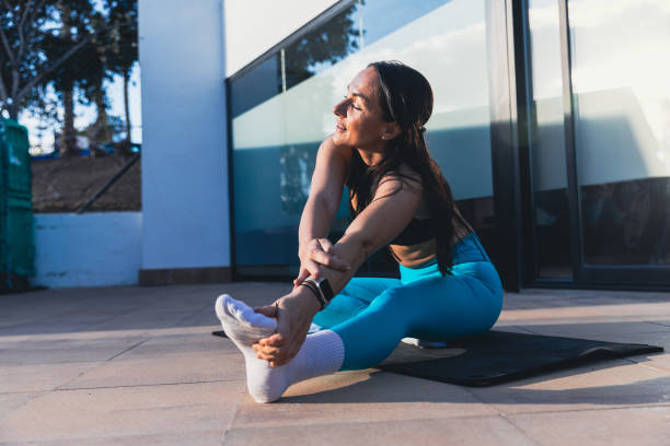 istock A woman is stretching her leg on a mat and relaxing 2195336968