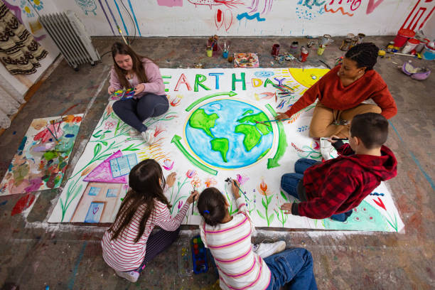 istock Children and Teacher Creating Earth Day Poster 2195337137