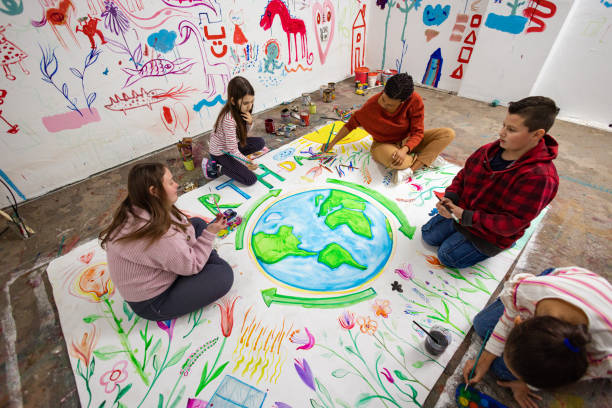 istock Teacher Helping Students Create an Earth Day Poster 2195337326