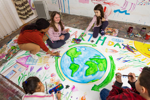 istock Little Artists and Teacher Making a Big Earth Poster 2195337718